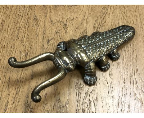 A Victorian brass 'Beatle' boot pull by Edmund Ashworth, Bradford.