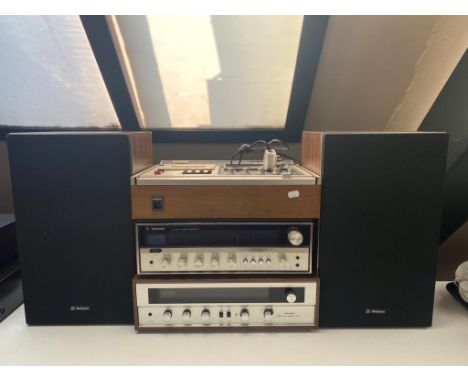 A Technics direct drive cassette stereo deck RS-279US together with a Technics FM AM stereo receiver, a Sansui stereo tuner a