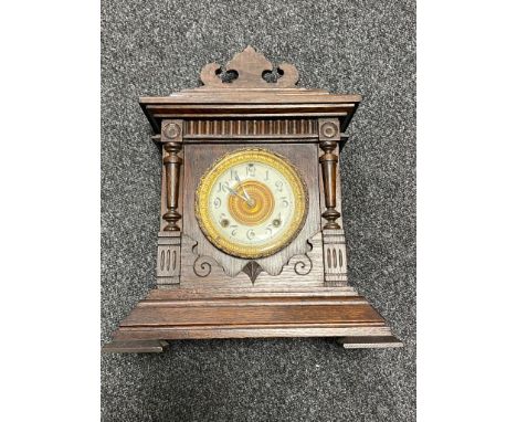 An antique American 8 day mantel clock by The Ansonia Clock Company with pendulum and key 
