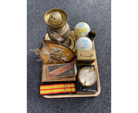 A tray of brass oil lamp, globe ornaments, ammunition shell, Rolls razor etc 