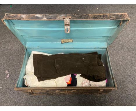 An early twentieth century tin trunk containing vintage clothing 