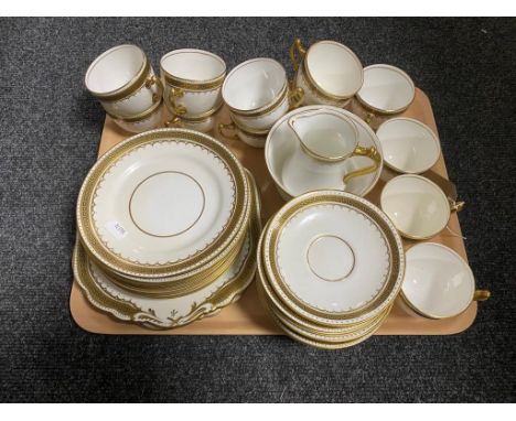A tray of antique white and gilt tea service