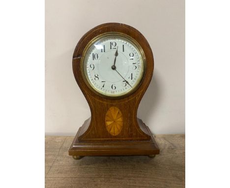 An inlaid mahogany balloon mantel clock with enamel dial on brass feet