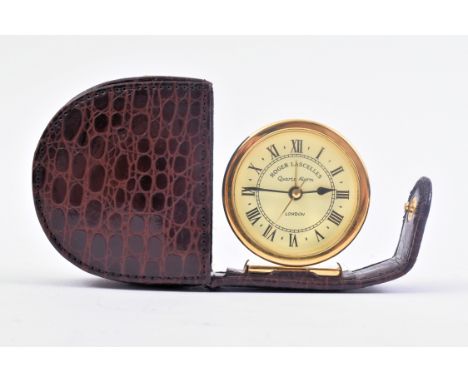 Roger Lascelles - a mid 20th century quartz alarm clock with Roman dial, presented in a pocket sized maroon leather case and 