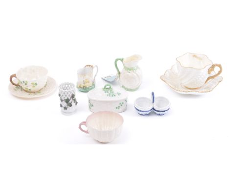 A collection of early 20th century naturalistic pottery, mostly Belleek, comprising small pouring jug in the form of a shell,