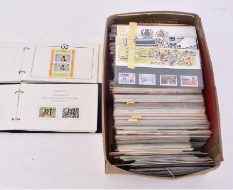 A collection of 1970s - 1990s Royal Mail mint commemorative stamps, each presented unopened in the packaging, along with Isle