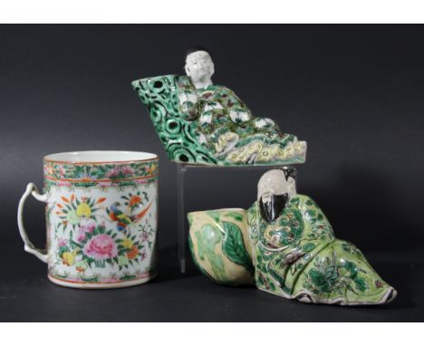 TWO CHINESE FAMILLE VERTE WATER DROPPERS, cast as a recumbent figure beside a peach or trunk, length 19cm; together with a fa