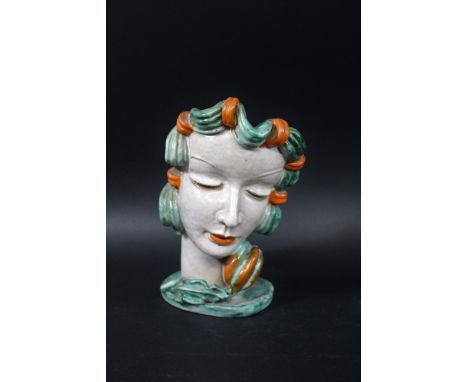 GOLDSCHEIDER FACE MASK ON STAND - RUDOLF KNORLEIN an unusual terracotta face mask designed by Rudolf Knorlein, with orange an