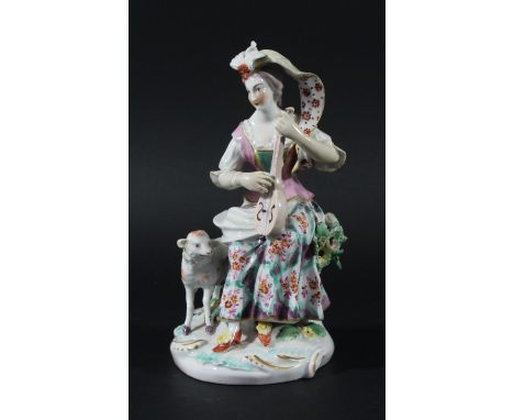 DERBY PATCH MARK FIGURE OF A SHEPHERDESS, seated playing a mandolin, a sheep to her side, height 19cm