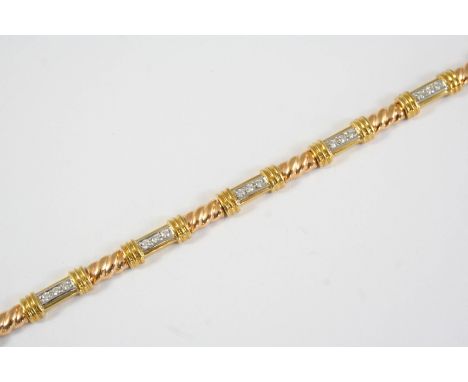 A DIAMOND AND 18CT GOLD BRACELET the rope link bracelet is mounted with seven gold sections each millegrain set with three ci