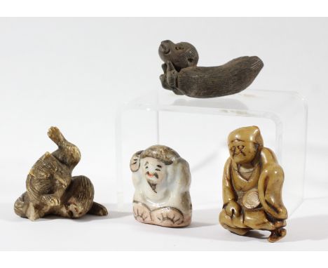 JAPANESE CARVING OF A CAT, possibly bone; a netsuke of a seated man; and two other figures (4)