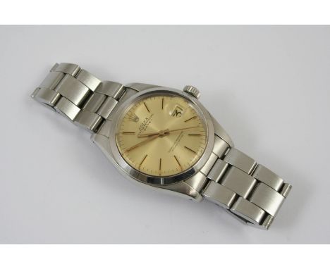 A GENTLEMAN'S STAINLESS STEEL OYSTER PERPETUAL DATE WRISTWATCH BY ROLEX the gold coloured dial with baton numerals, model no 