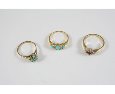 A TURQUOISE AND DIAMOND RING the three graduated oval-shaped turquoise cabochons are set with four rose-cut diamonds, in gold