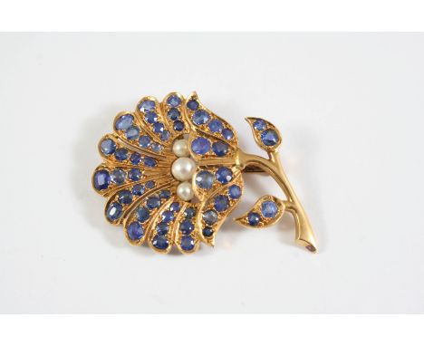 A SAPPHIRE, CULTURED PEARL AND GOLD FOLIATE BROOCH mounted with three cultured pearls and overall with graduated circular and