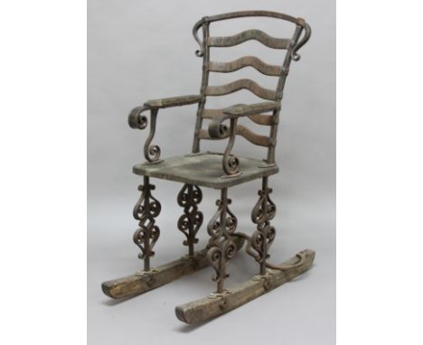 ARTS &amp; CRAFTS IRON &amp; WOODEN ROCKING CHAIR an interesting 19thc chair with a wooden seat and rockers, with a heavily m