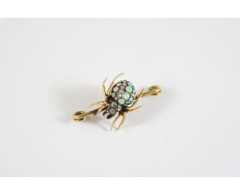 AN EARLY 20TH CENTURY OPAL AND DIAMOND SPIDER BROOCH the body set with circular solid white opals and rose-cut diamonds, in g