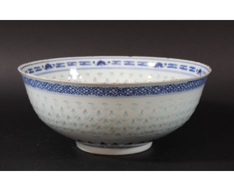 CHINESE BLUE AND WHITE RICE PATTERN BOWL, 19th century, a central stork and flowers inside a translucent band and a border of