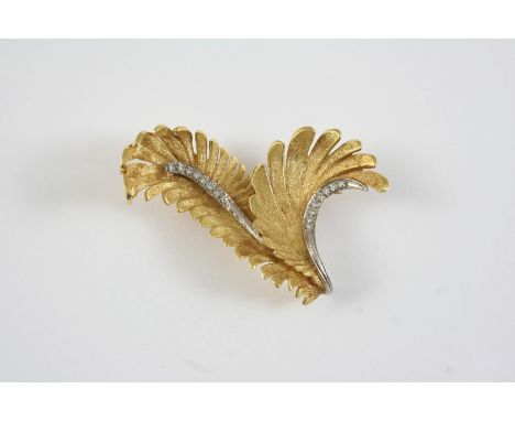 AN 18CT GOLD AND DIAMOND BROOCH BY E. PEARL the fern design is set with circular-cut diamonds, 4.5cm long, 15.1 grams