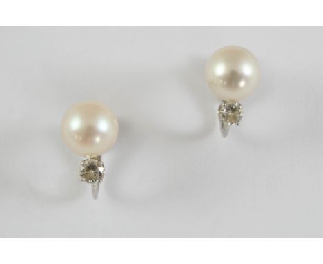 A PAIR OF CULTURED PEARL AND DIAMOND EARRINGS each earring set with a cultured pearl measuring approximately 8.5mm and a circ