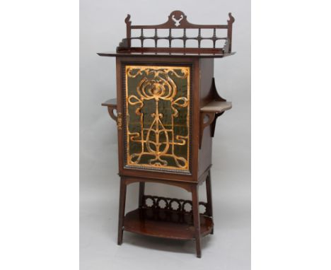 ART NOUVEAU MUSIC CABINET a mahogany cabinet, with a frosted glass door overlaid with copper mount of Art Nouveau design. Wit