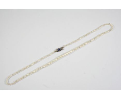 A SINGLE ROW GRADUATED NATURAL PEARL NECKLACE the one hundred and fifty seven pearls graduate to a clasp mounted with an oval
