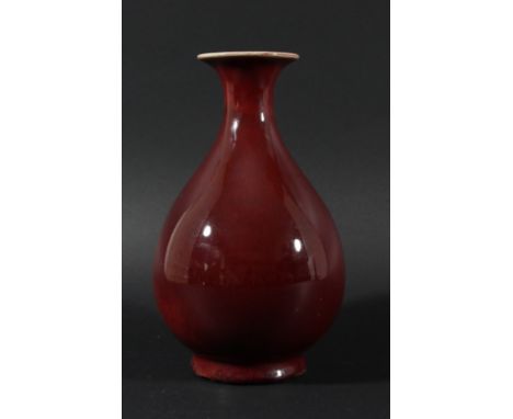 CHINESE SANG DE BOEUF VASE, Qianlong mark but probably later, of baluster form, red shading to cream at the rim, six characte