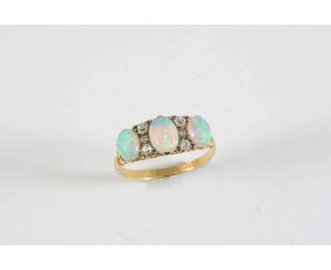 A VICTORIAN OPAL AND DIAMOND RING the three graduated oval solid white opals are millegrain set with six circular-cut diamond