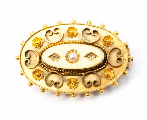 A Victorian gilt metal oval brooch, set with a seed pearl and two diamonds, 3cm wide