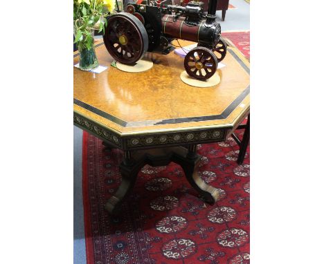 A late 19th century octagonal amboyna veneered centre table, in the French taste, the top with bone stringing and ebony bandi