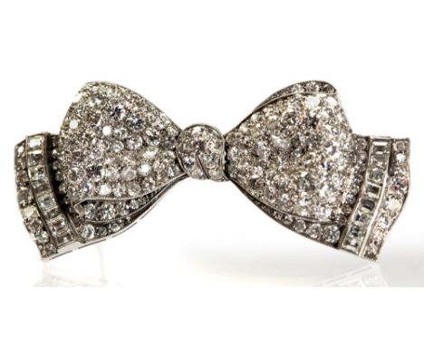 A platinum and diamond bow brooch, set with graduated round-cut and step-cut stones, 5.5cm wide, 16.3g