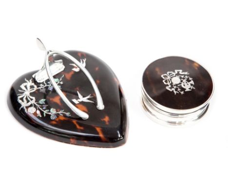 An Edwardian silver and tortoiseshell letter clip with the form of a heart with wishbone clip, inlaid with silver and mother 