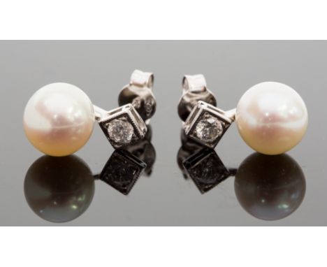 A pair of 18ct white gold, pearl and diamond earrings, total diaond weight approx 0.30ct, the button pearls approx 8.6mm diam