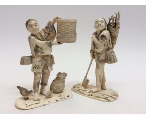 A pair of 19th century carved ivory figures of farmers, one with an axe, carrying a bundle of branches, the other with basket