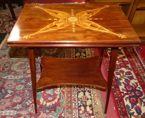 A circa 1900 mahogany and stylised floral inlaid fold-over card table, having a baize lined interior, with swivel action and 