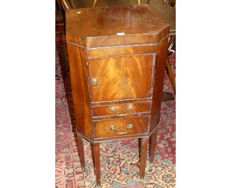 An early 19th century mahogany hinge topped night commode, with single cupboard door, pull-out lower drawer (lacking one rear