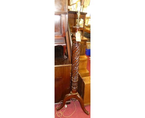 A floral carved spiral turned mahogany freestanding standard lamp, raised on hipped supports, h.141cm (excluding fittings)