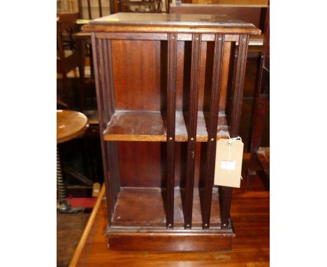 A contemporary mahogany square two-tier small bookcase, raised on roller castors, w.34cm