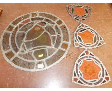 A Victorian stained glass circular lead light, dia.44cm; together with three other smaller triangular shield shaped lead ligh