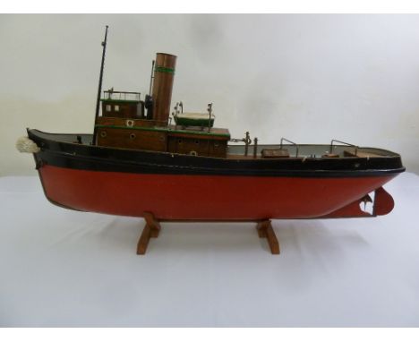 A working model of a tug boat with steam powered engine to include wooden stand  A/F