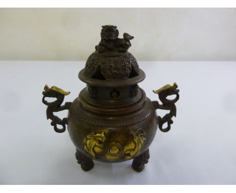 A Chinese early 20th century bronze incense burner with lion finial to domed cover