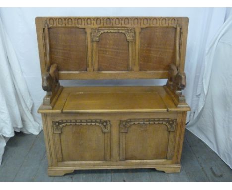 Reproduction oak Monks bench, two lion carved side handles with hinged seat and back