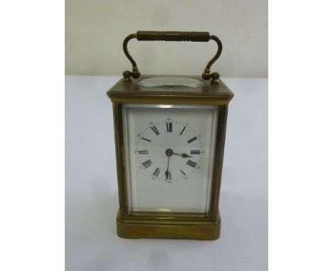 A brass time piece carriage clock of customary form