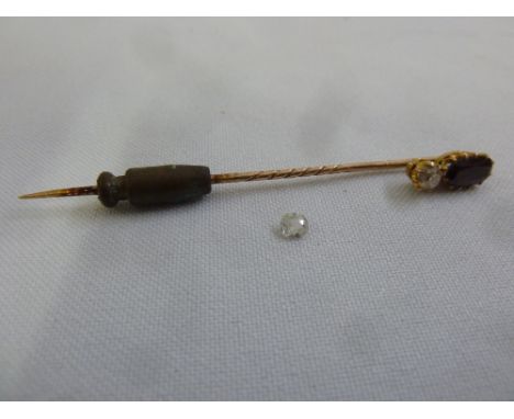 A 9ct gold tie pin set with a garnet and a diamond and a loose diamond