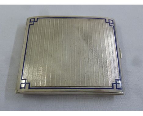 A white metal and enamel engine turned cigarette case