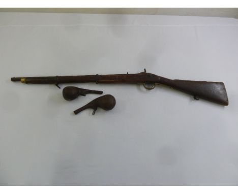 A 19th century flintlock rifle and two leather shot holders