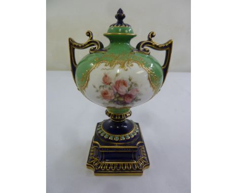 A Royal Worcester covered vase, compressed spherical form with two side handles of flared rectangular base, the sides decorat