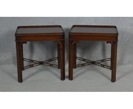 A pair of Georgian style mahogany lamp or bedside tables on chamfered square section pierced stretchered  supports. H.51.5 L.
