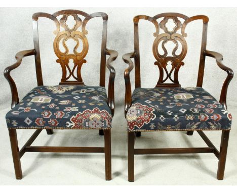 A pair of Georgian mahogany Chippendale style open armchairs with pierced back splat on chamfered square section supports. H.