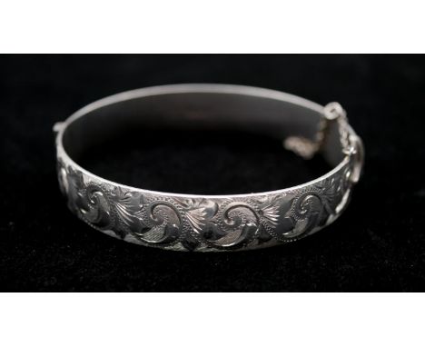 A Georg Jensen engraved silver clip bangle, engraved with a stylised foliate and floral design. Hallmarked: GJLd for Georg Je