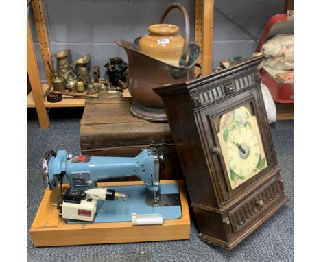 A tin trunk with a copper coal skuttle, stoneware jar, sewing machine and wooden wall cabinet.